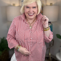 Woman wearing a red gingham button down top