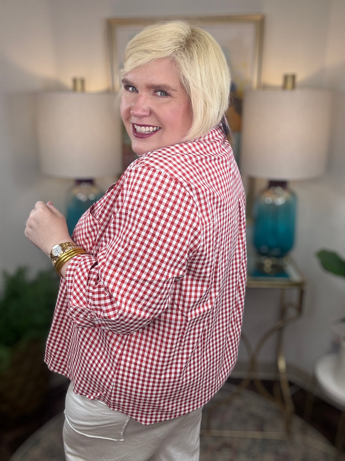 Woman wearing a red gingham button down top