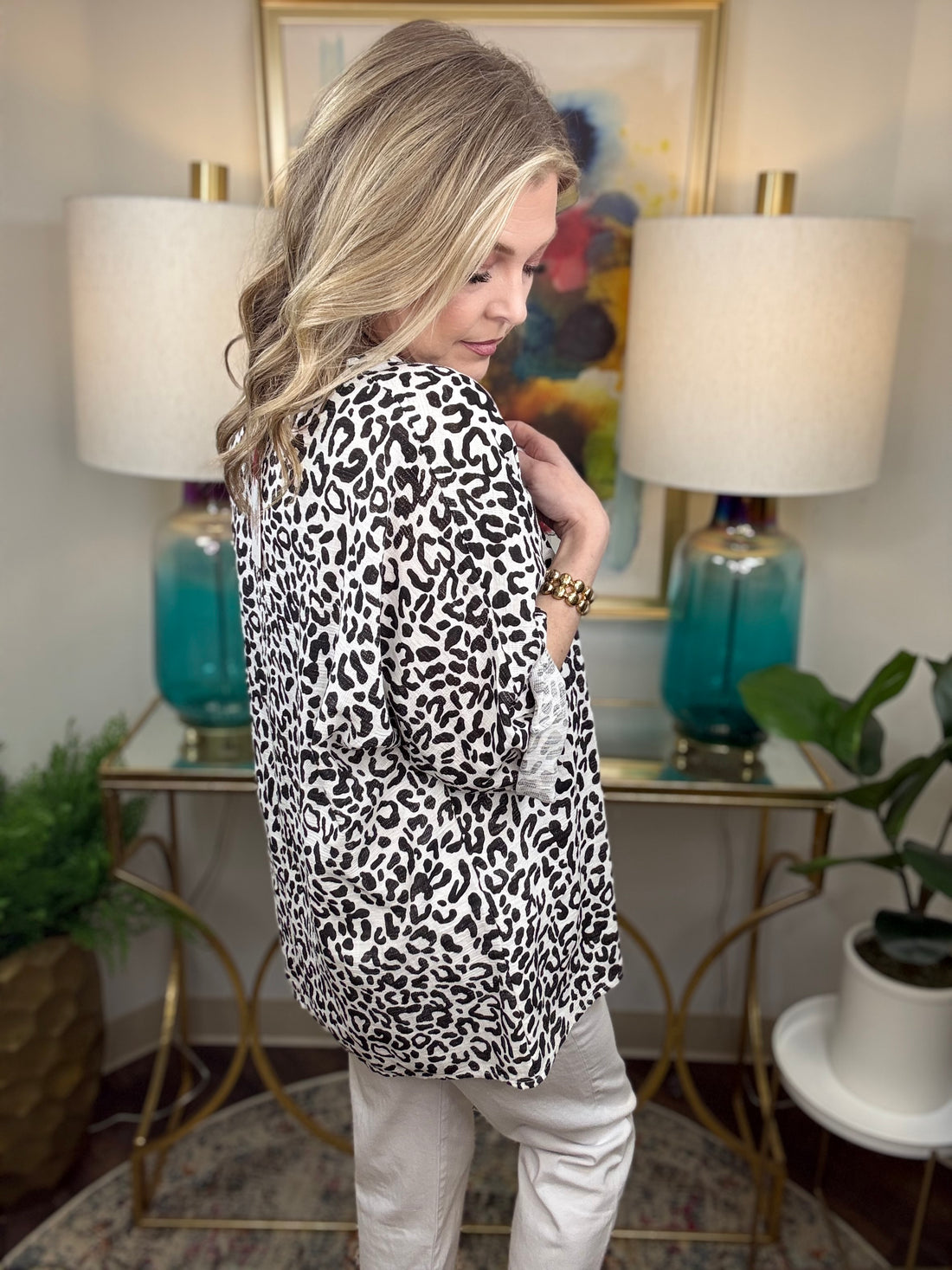 Woman wearing a white leopard print top