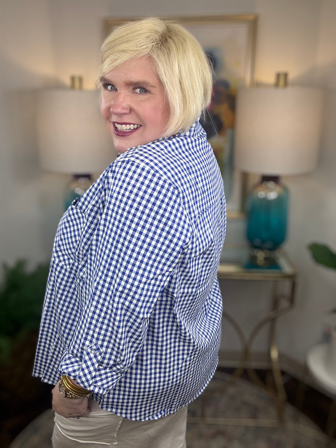 Woman wearing a royal blue gingham button down top