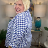 Woman wearing a royal blue gingham button down top
