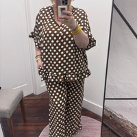 matching brown and white polka dot lounge set, featuring a short-sleeve V-neck top and wide-leg pants with ruffle hems