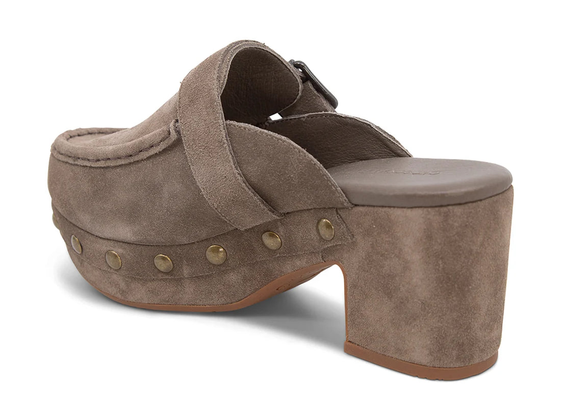 The Genni platform mule boasts a suede upper accented with aged-finish hardware and a loafer-inspired topline distinguish a retro suede mule