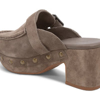 The Genni platform mule boasts a suede upper accented with aged-finish hardware and a loafer-inspired topline distinguish a retro suede mule
