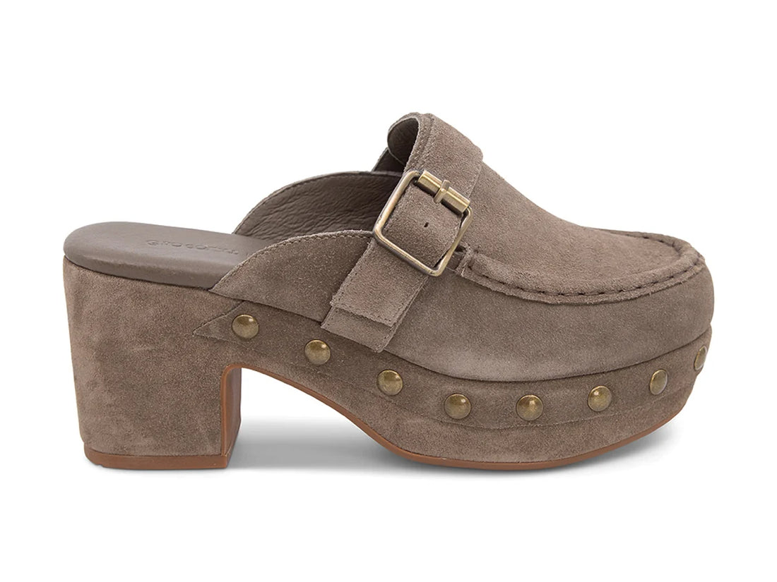 The Genni platform mule boasts a suede upper accented with aged-finish hardware and a loafer-inspired topline distinguish a retro suede mule