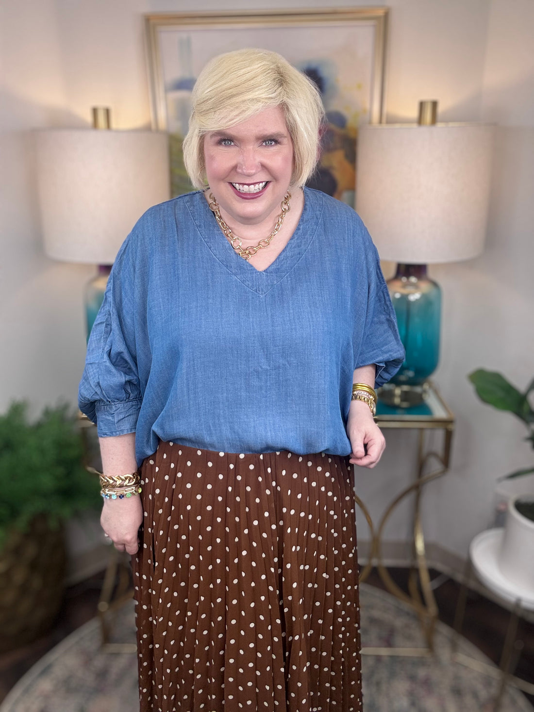 Woman wearing a denim v-neck dolman sleeve blouse