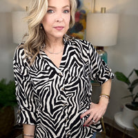 Women’s zebra print blouse with classic button-up design