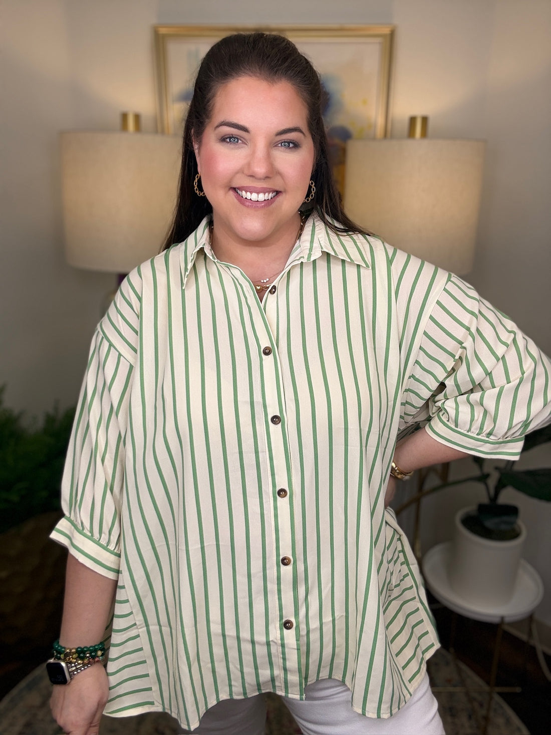 Woman wearing a green and cream striped shirt top