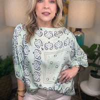 Woman wearing a mint bandana style top