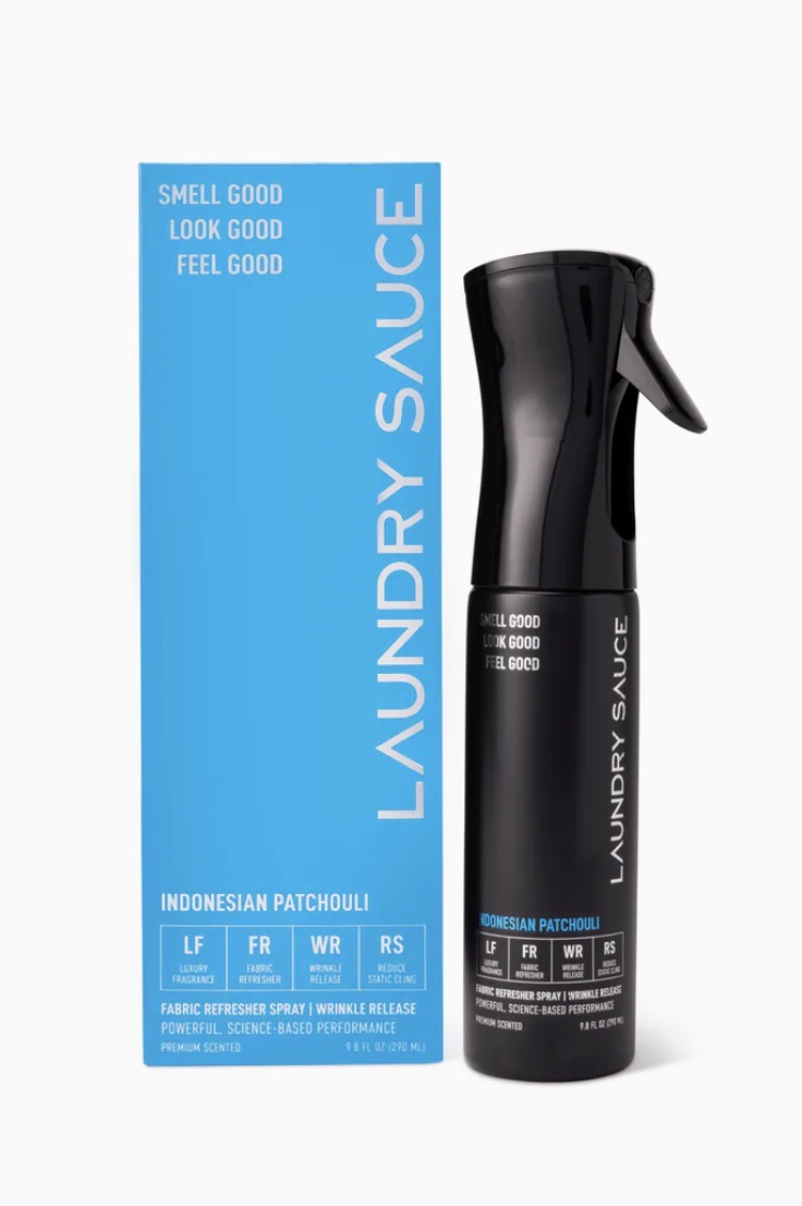 Black laundry spray bottle with blue packaging labeled &