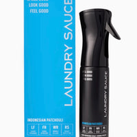 Black laundry spray bottle with blue packaging labeled 'Laundry Sauce' on a white background