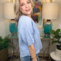 Woman wearing blue linen top