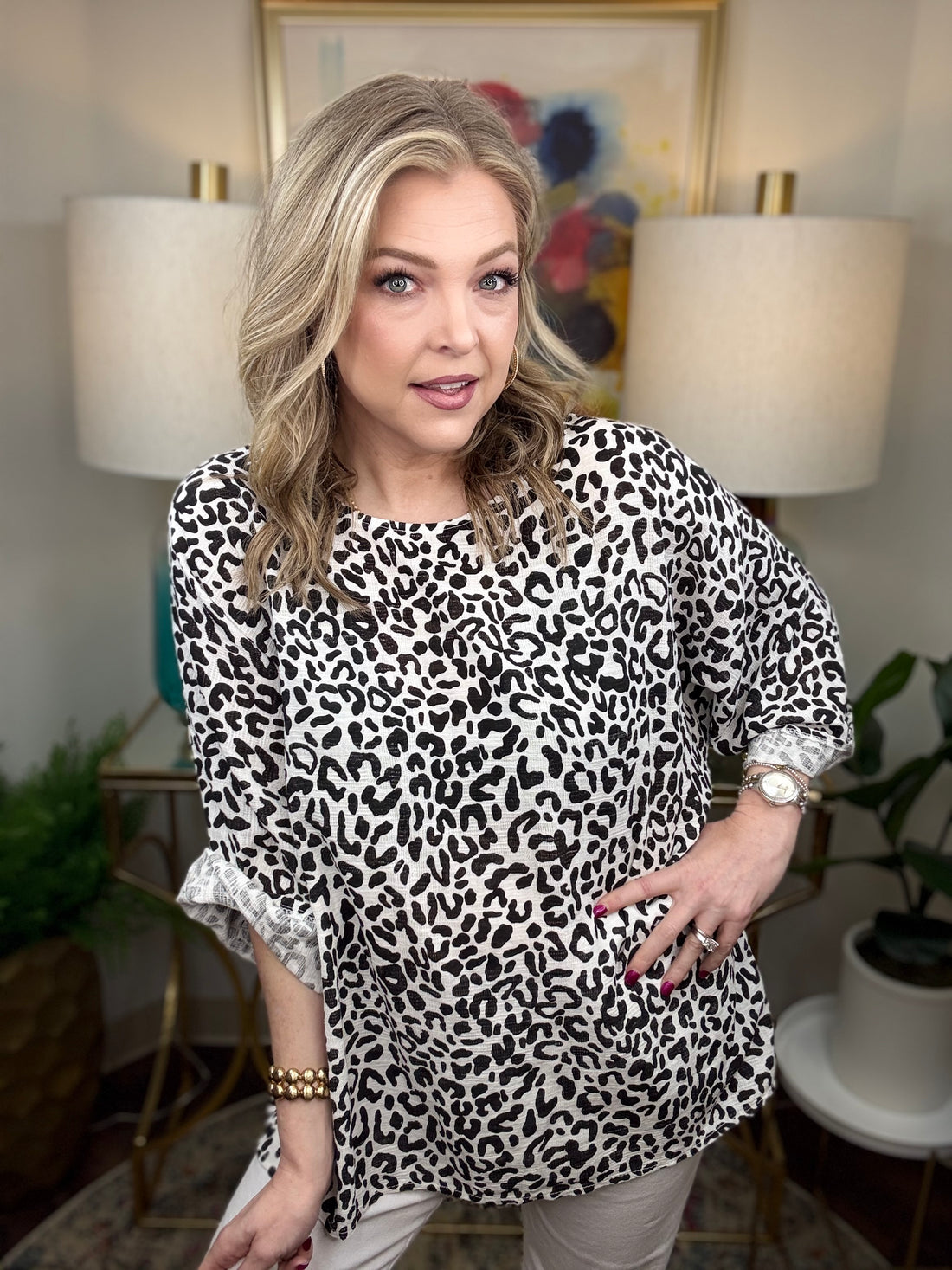 Woman wearing a white leopard print top