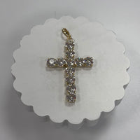 Gold cross pendant with clear stones on a white scalloped card