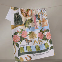 Decorative towel with 'Greetings from Alabama' text and various state symbols 
