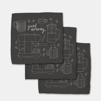 Set of three black towels with white coffee-themed designs.