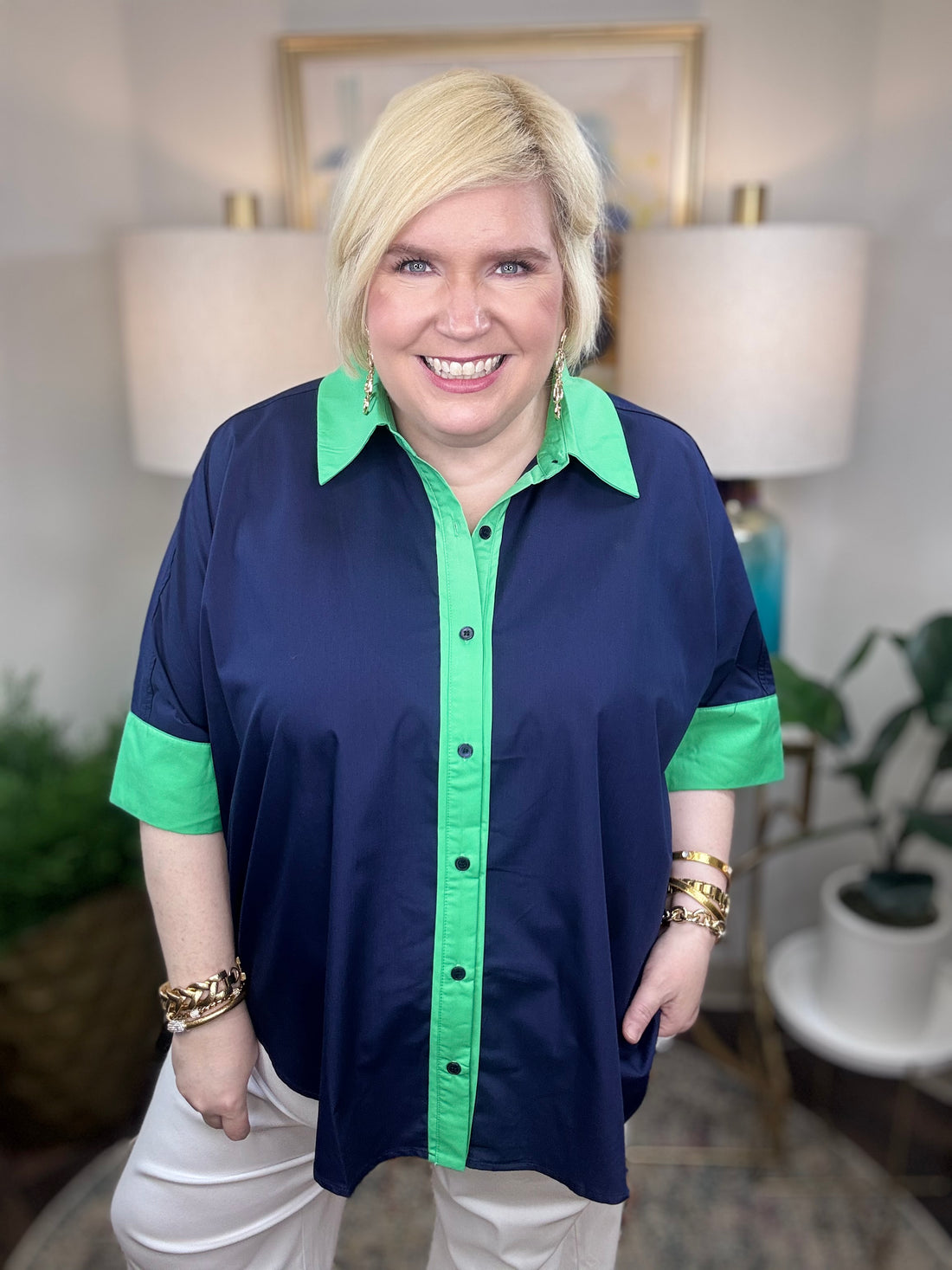 Woman wearing a navy shirt with green color-block accents.