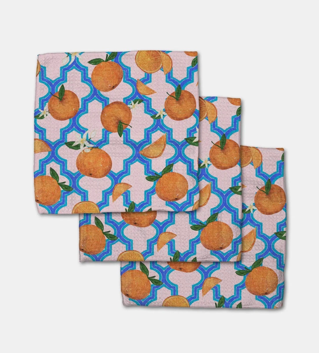 Set of three dishcloths with a pattern of oranges on a geometric blue and light pink background