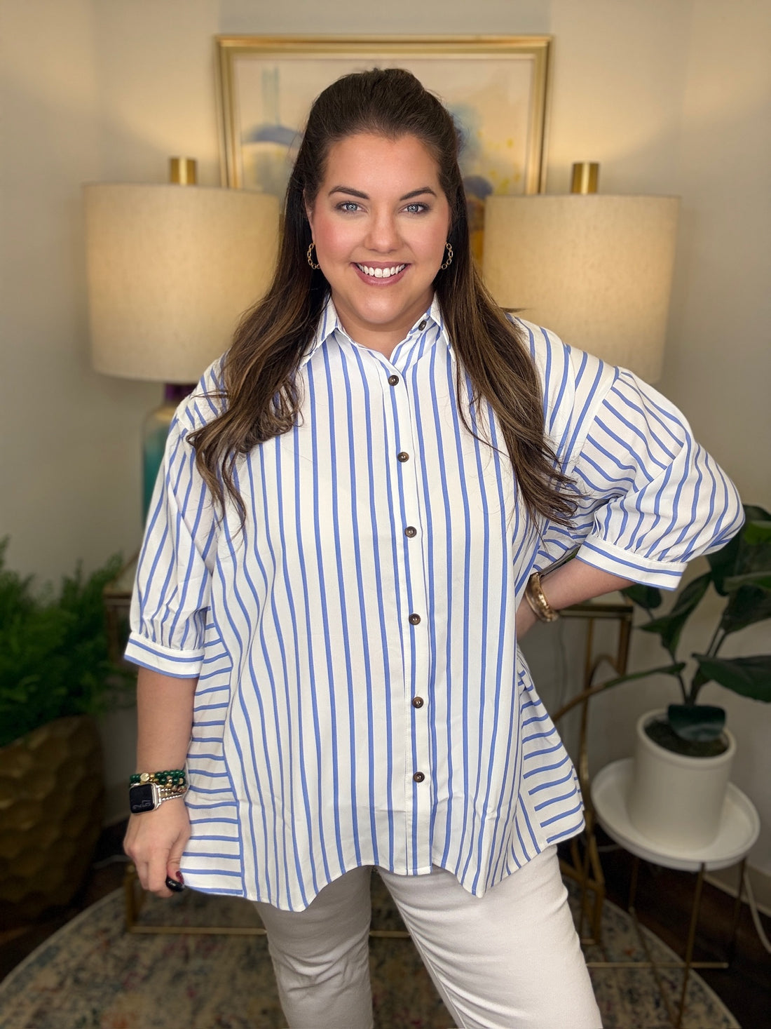 Woman wearing a blue and white striped shirt top
