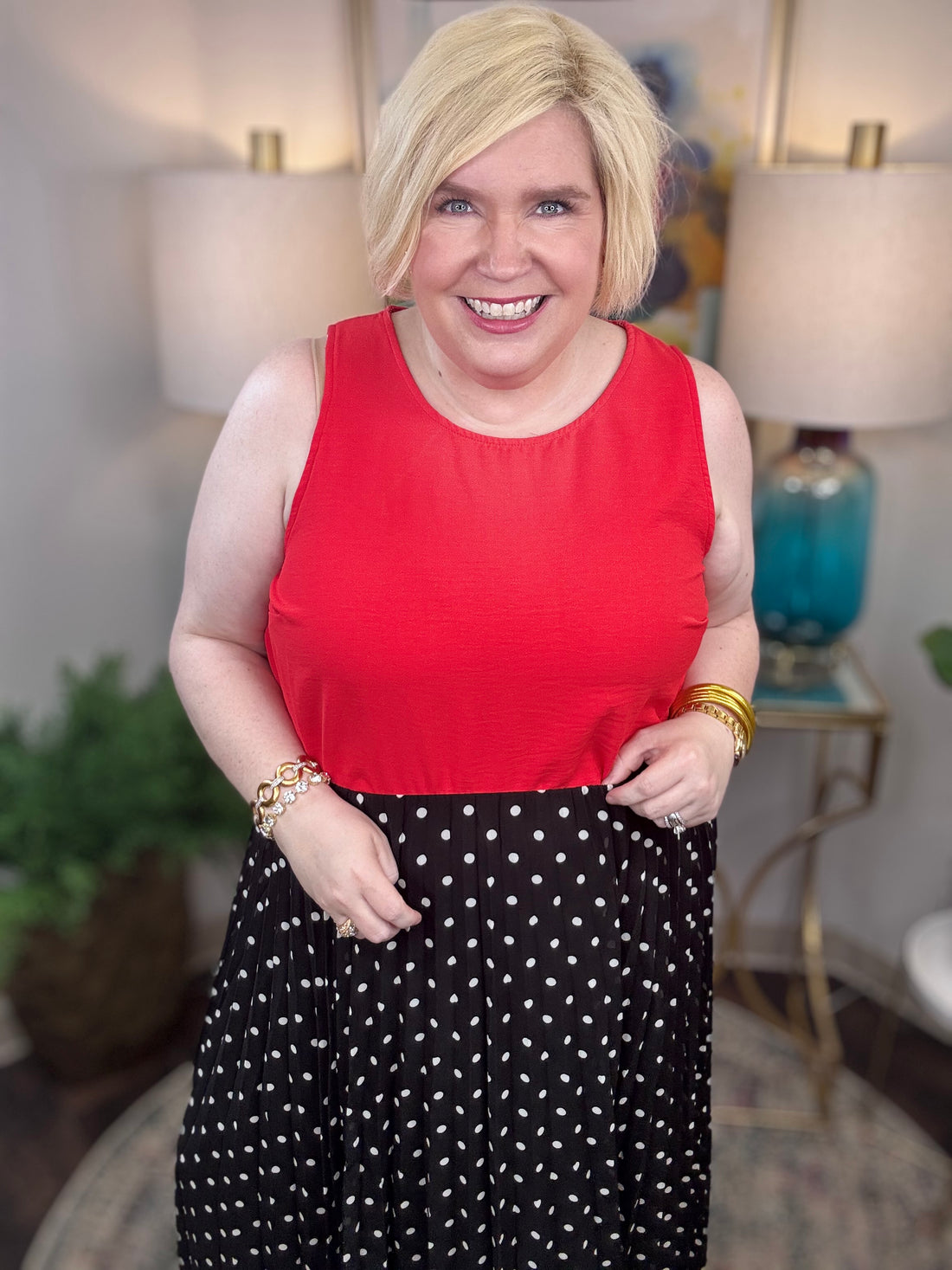 Woman wearing a red top and black polka dot skirt