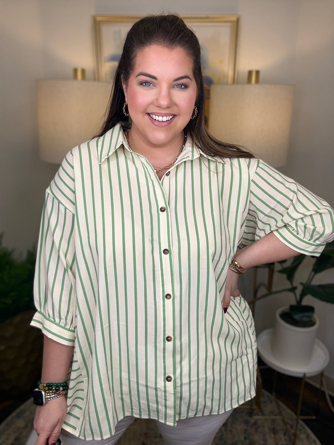 Woman wearing a green and cream striped top