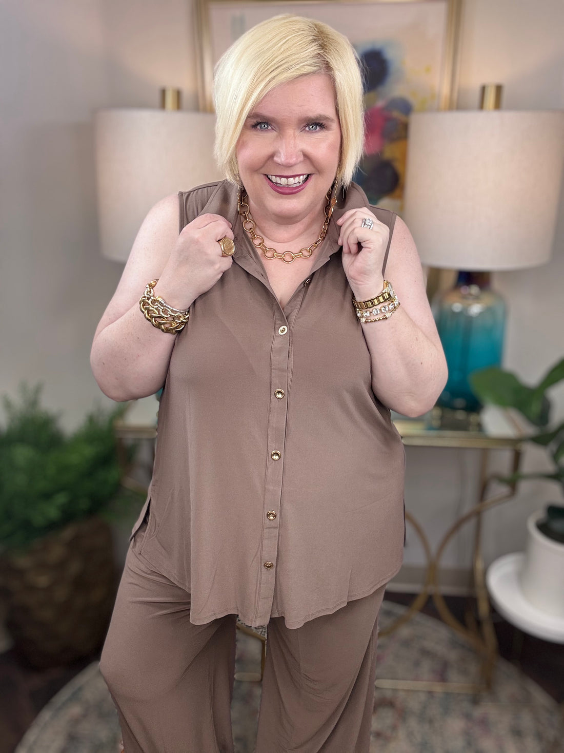 Woman wearing a brown mocha sleeveless top and pants with gold buttons