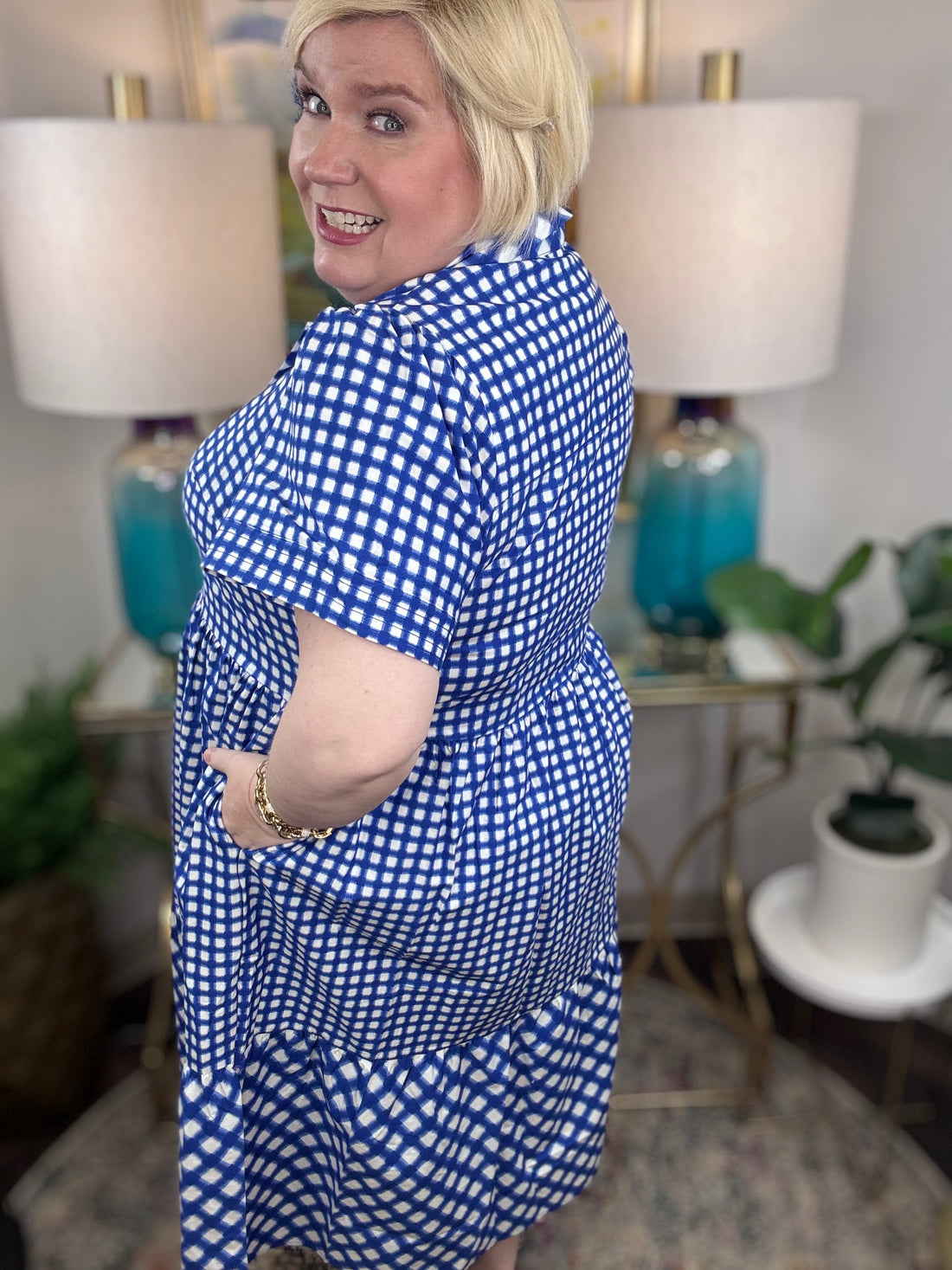 Woman wearing a blue and white checkered maxi dress.