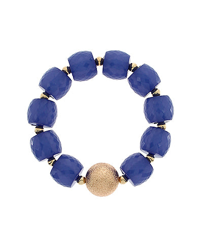 Blue beaded bracelet with a gold accent on a white background