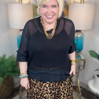 Woman wearing a black mesh top