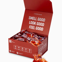 Red box of laundry detergent packets with text 'Smell Good, Look Good, Feel Good' on a white background.