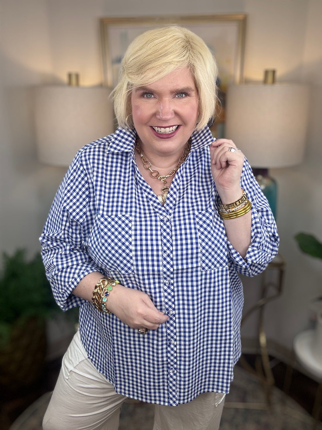 Woman wearing a royal blue gingham button down top