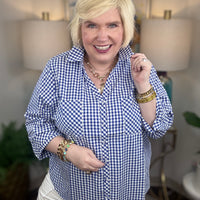 Woman wearing a royal blue gingham button down top