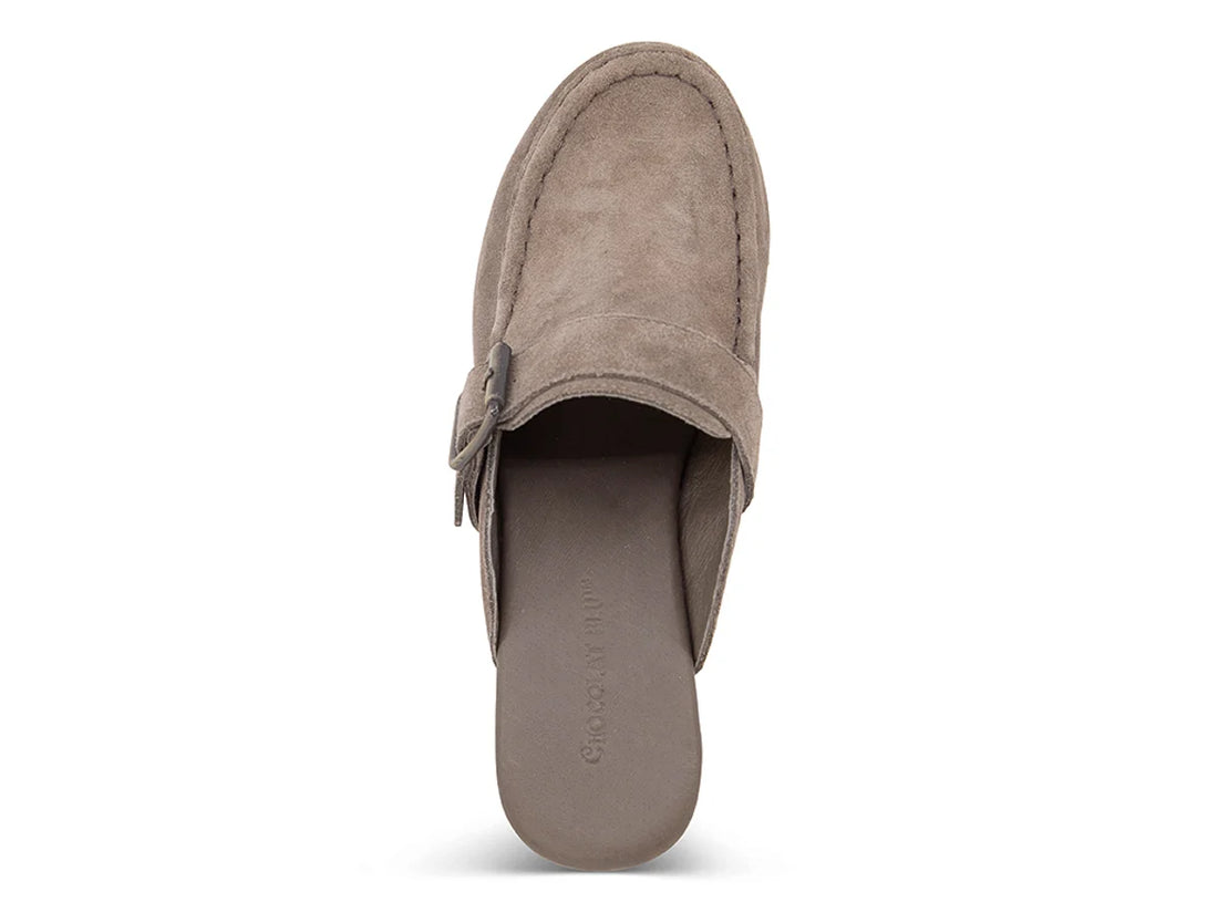 The Genni platform mule boasts a suede upper accented with aged-finish hardware and a loafer-inspired topline distinguish a retro suede mule