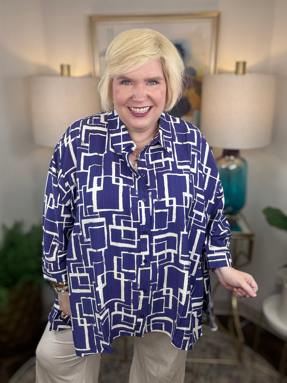 Woman wearing a blue and white geometric patterned shirt