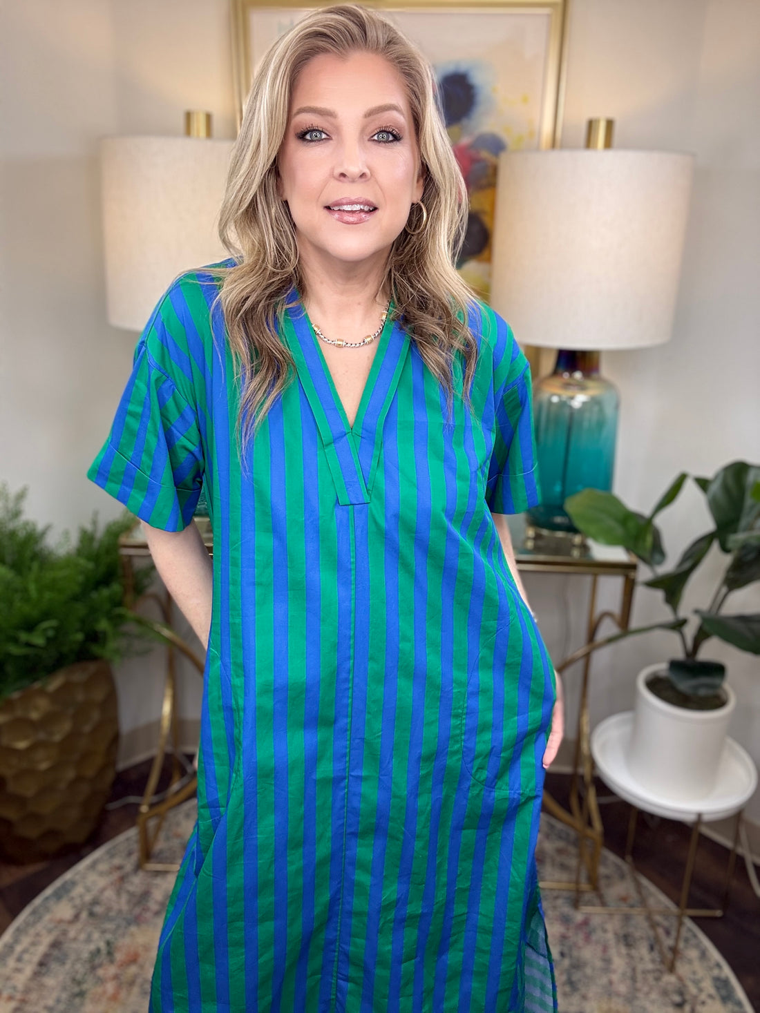 Woman wearing a blue and green striped dress