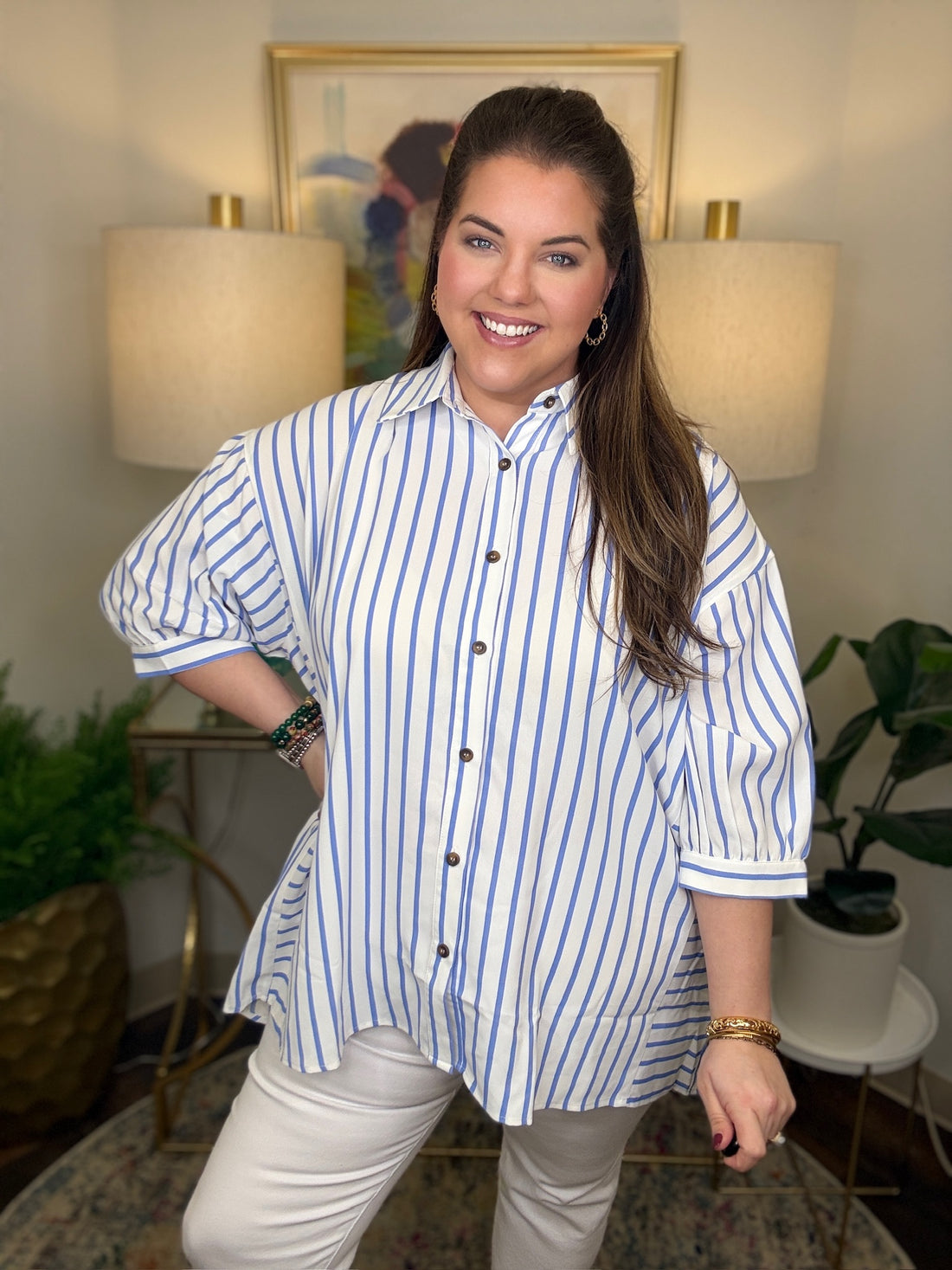 Woman wearing a blue and white striped shirt top