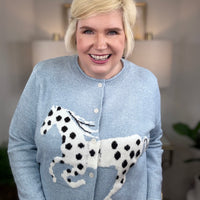 Light blue cardigan with white horse and black spots