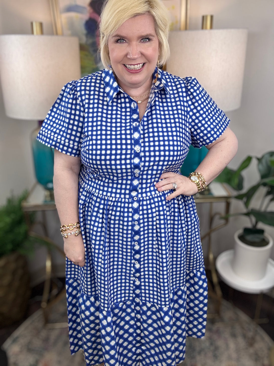 Woman wearing a blue and white checkered maxi dress.