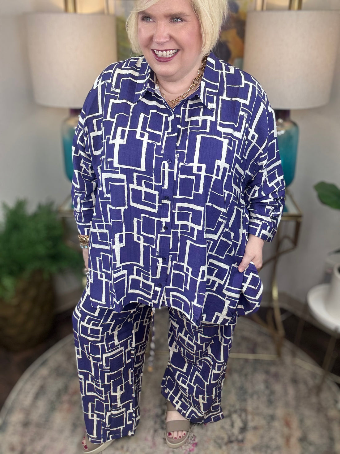 Woman wearing a blue and white geometric patterned shirt and pants