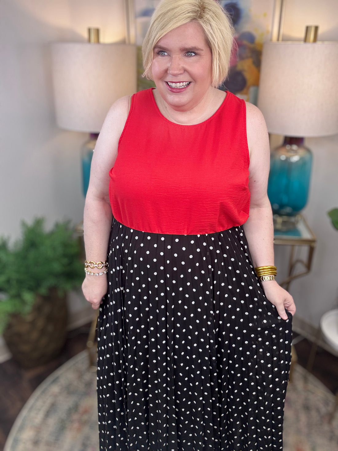 Woman wearing a red top and black polka dot skirt