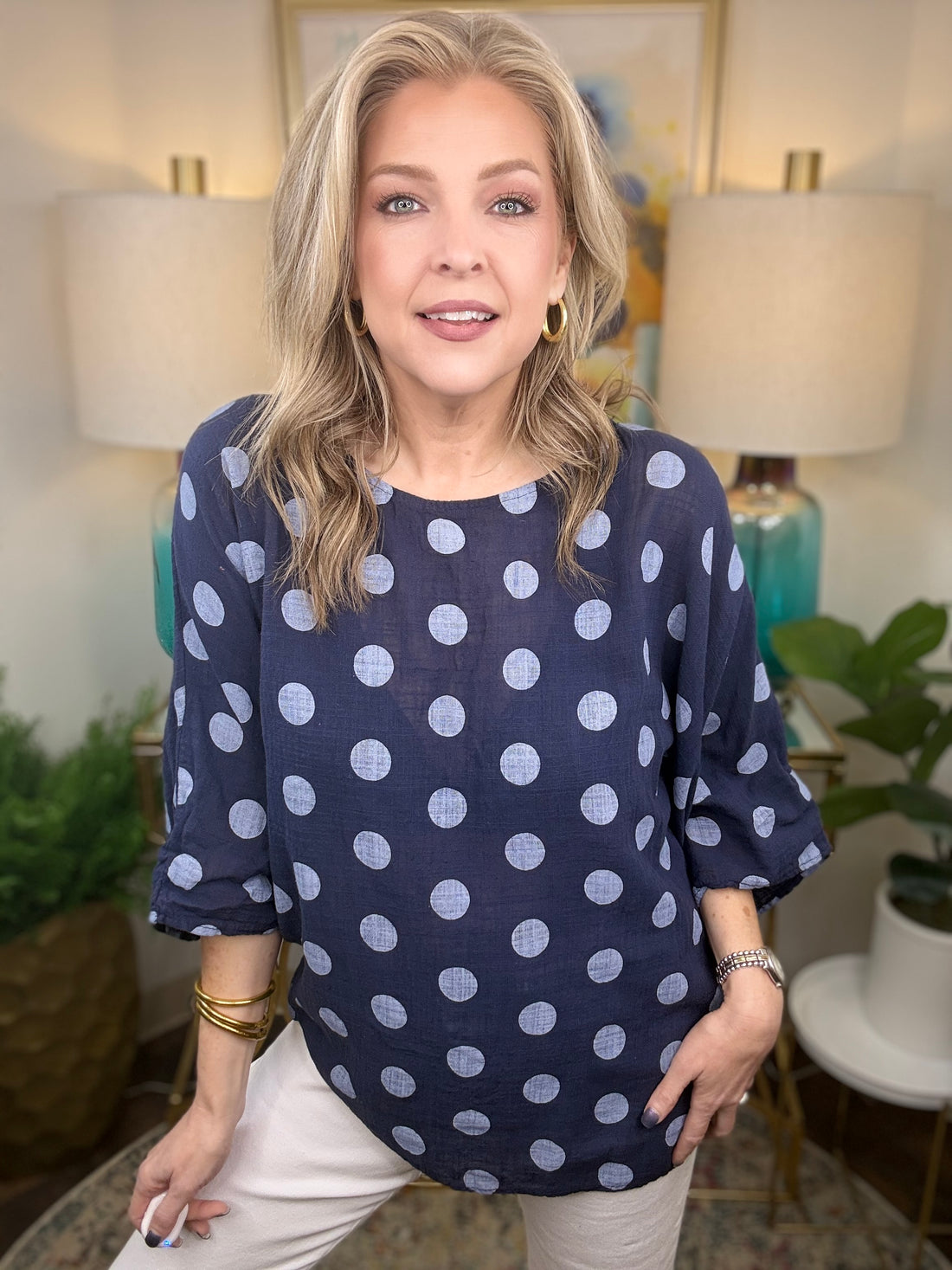 Woman wearing navy blue polka dot top 
