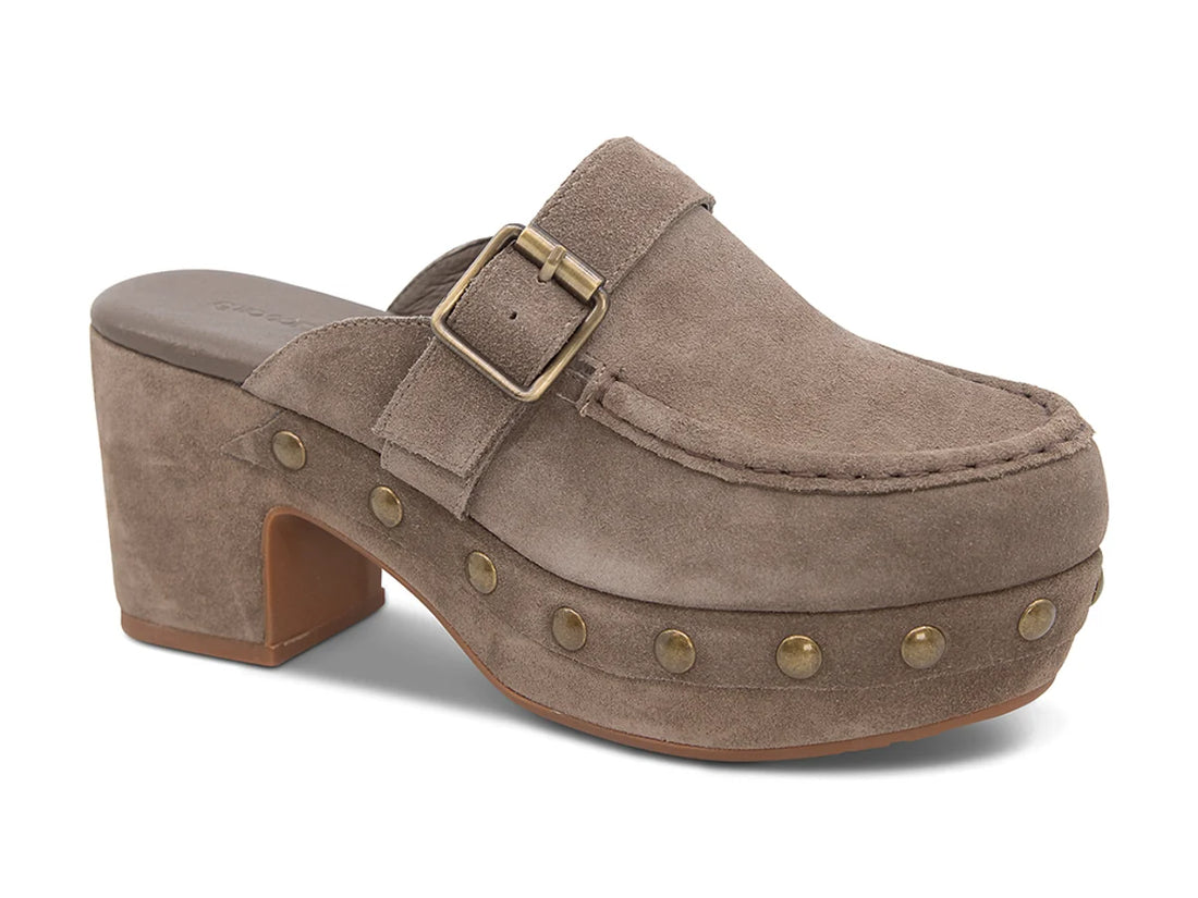 The Genni platform mule boasts a suede upper accented with aged-finish hardware and a loafer-inspired topline distinguish a retro suede mule