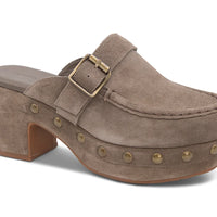 The Genni platform mule boasts a suede upper accented with aged-finish hardware and a loafer-inspired topline distinguish a retro suede mule
