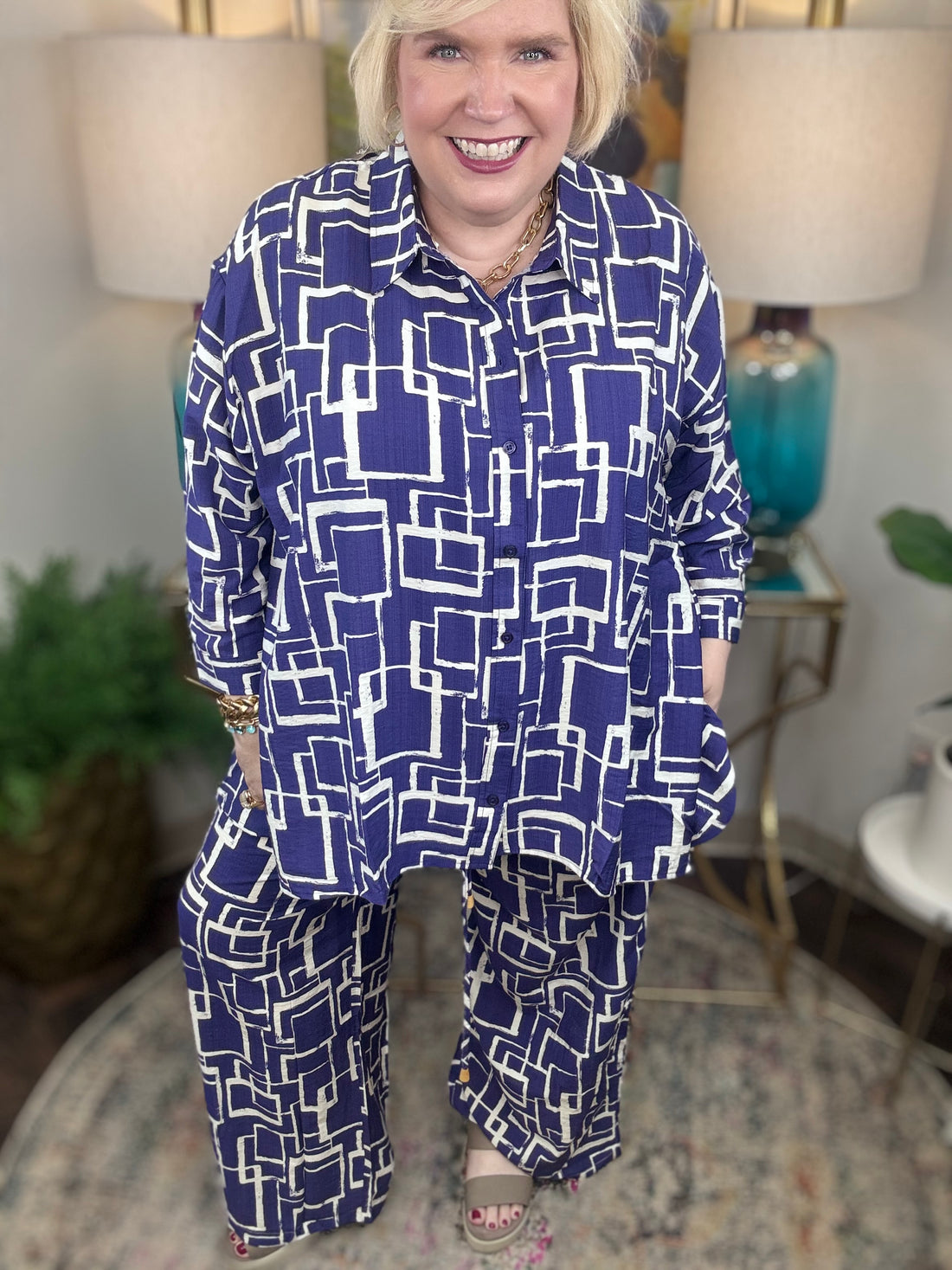 Woman wearing a blue and white geometric patterned shirt