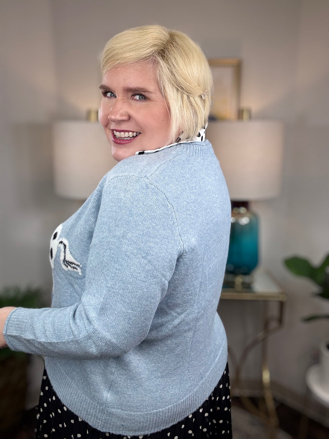 Light blue cardigan with white horse and black spots