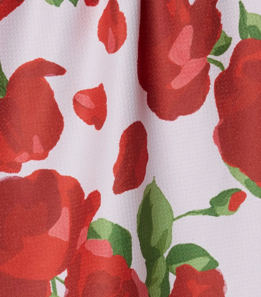 Close-up of fabric with red floral pattern on a white background