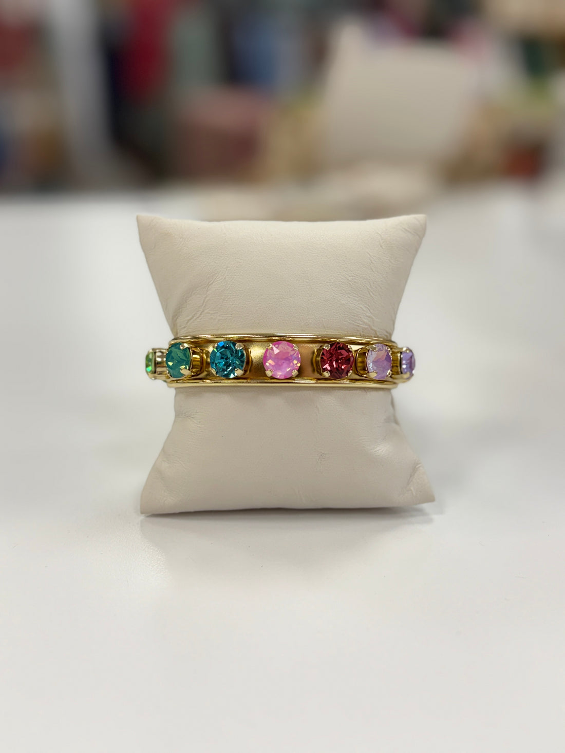 Gold cuff bracelet with multi-colored stones