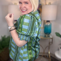 Women's patterned button-down top with ruffle details