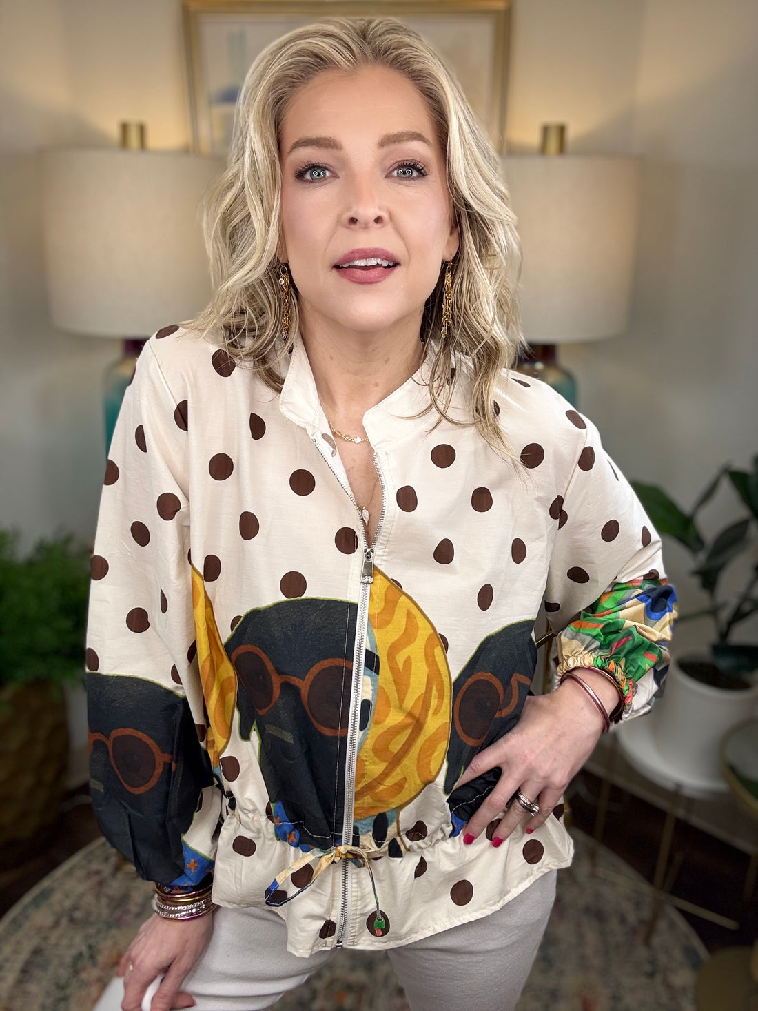 Woman modeling a jacket with puppies and polka dots patterned on it