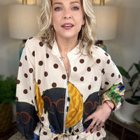 Woman modeling a jacket with puppies and polka dots patterned on it